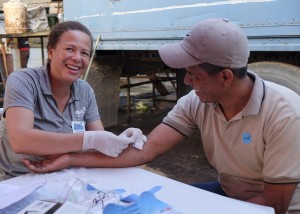 A Bridge of Life volunteer screens a migrant worker for chronic kidney disease